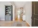 Welcoming foyer featuring hardwood floors, stylish built-in shelving, and a staircase to the upper level at 3102 Fox Sedge Pl, Highlands Ranch, CO 80126