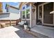 Inviting front porch with porch swing, potted flowers, and decorative lanterns, creating a cozy entryway at 3102 Fox Sedge Pl, Highlands Ranch, CO 80126