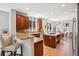 Open kitchen showcasing a breakfast bar, island cooktop, granite countertops, and stainless steel appliances at 3102 Fox Sedge Pl, Highlands Ranch, CO 80126