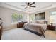 Spacious bedroom with tray ceilings, a ceiling fan, and lots of natural light at 3102 Fox Sedge Pl, Highlands Ranch, CO 80126
