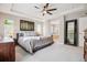 Large main bedroom with tray ceilings, a ceiling fan, and en suite bath at 3102 Fox Sedge Pl, Highlands Ranch, CO 80126