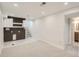 Open basement area with stylish flooring, stairs, laundry, and bathroom access, offering functional living space at 5555 Julian St, Denver, CO 80221