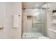 Bathroom features modern fixtures, glass enclosed shower, and built in shelf at 5555 Julian St, Denver, CO 80221