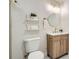 Bathroom features modern fixtures, a vanity with storage, and floating shelves for extra storage at 5555 Julian St, Denver, CO 80221