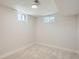 A room with neutral carpet, small windows, and white walls ready to be transformed into a cozy bedroom retreat at 5555 Julian St, Denver, CO 80221
