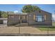 Charming home with a modern exterior, featuring dark siding, brick accents, and well-kept landscaping at 5555 Julian St, Denver, CO 80221