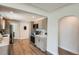 Modern kitchen features sleek appliances, light wood cabinetry, and an adjacent dining area at 5555 Julian St, Denver, CO 80221