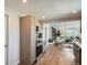 Open kitchen with modern appliances, light wood cabinets, and seamless access to the dining and living areas at 5555 Julian St, Denver, CO 80221