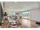 Bright living room features hardwood floors, recessed lighting, and large windows offering lots of natural light at 5555 Julian St, Denver, CO 80221