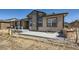 Exterior view of the home's backyard featuring a patio area, built-in grill, and well-manicured landscaping at 11926 Barrentine Loop, Parker, CO 80138