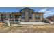 Backyard view with a patio, grill, and well-maintained lawn, perfect for outdoor entertaining and relaxation at 11926 Barrentine Loop, Parker, CO 80138