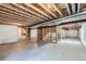 Spacious unfinished basement with visible ductwork, concrete floors, and framed staircase, awaiting personalization at 11926 Barrentine Loop, Parker, CO 80138