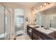 En-suite bathroom featuring dual vanity with granite counter and updated fixtures at 11926 Barrentine Loop, Parker, CO 80138