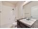 Bathroom featuring shower-tub combo, tile flooring, and modern vanity at 11926 Barrentine Loop, Parker, CO 80138