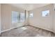 Sunlit bedroom features plush carpeting and natural light from multiple windows at 11926 Barrentine Loop, Parker, CO 80138