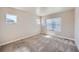 A bright bedroom featuring neutral walls, plush carpeting, and large windows at 11926 Barrentine Loop, Parker, CO 80138