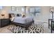 Cozy bedroom featuring neutral walls, plush carpet, and a comfortable bed with stylish patterned rug at 11926 Barrentine Loop, Parker, CO 80138