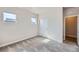A sunlit bedroom featuring plush carpeting and large windows at 11926 Barrentine Loop, Parker, CO 80138