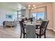 Elegant dining area with backyard views, adjacent to the living room and open-concept kitchen at 11926 Barrentine Loop, Parker, CO 80138