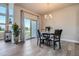 Dining area with a modern light fixture and a sliding glass door leading to the outdoors at 11926 Barrentine Loop, Parker, CO 80138