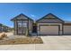 Charming exterior with a two-car garage, stone accents, and a well-maintained lawn at 11926 Barrentine Loop, Parker, CO 80138