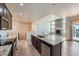 Open concept kitchen with granite island and view of living room fireplace at 11926 Barrentine Loop, Parker, CO 80138