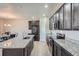 Modern kitchen with stainless steel appliances, granite countertops, and dark cabinetry at 11926 Barrentine Loop, Parker, CO 80138