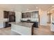 Modern kitchen boasts dark cabinets, granite countertops, and a central island at 11926 Barrentine Loop, Parker, CO 80138