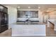 Kitchen island with granite countertops, stainless steel appliances, and dark cabinets at 11926 Barrentine Loop, Parker, CO 80138