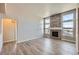 Bright living room featuring a stone fireplace, hardwood floors, and large windows at 11926 Barrentine Loop, Parker, CO 80138