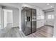 Kitchen featuring stainless steel appliances, white cabinets, and updated flooring at 1437 N Uinta St, Denver, CO 80220