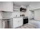 Bright kitchen with white cabinets, granite countertops, and stainless steel appliances at 1437 N Uinta St, Denver, CO 80220