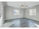 Inviting living room featuring updated gray flooring and a modern ceiling fan at 1437 N Uinta St, Denver, CO 80220