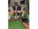 Landscaped backyard featuring a garden, flowers, and a well-manicured lawn at 4318 Fossil Way, Castle Rock, CO 80109