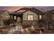Beautiful single-story home with a covered porch, stone accents and walkway lighting at 4318 Fossil Way, Castle Rock, CO 80109
