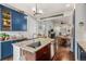 Kitchen island features a granite countertop, stainless sink, and wood cabinetry with views into the dining and living area at 4318 Fossil Way, Castle Rock, CO 80109