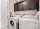 A dedicated laundry room with washer, dryer, and overhead storage at 4318 Fossil Way, Castle Rock, CO 80109