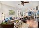 Comfortable living room with hardwood floors, plush seating, and views into the kitchen and dining area at 4318 Fossil Way, Castle Rock, CO 80109