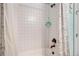 Bright shower with white tile and a floral shower curtain at 4318 Fossil Way, Castle Rock, CO 80109