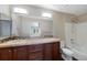 A modern bathroom featuring a double sink vanity with tile backsplash and a shower-tub combo at 8437 Thunder Ridge Way # 202, Highlands Ranch, CO 80126