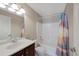 Bathroom featuring a single sink vanity and a shower-tub combo with curtain at 8437 Thunder Ridge Way # 202, Highlands Ranch, CO 80126