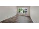 Bright bedroom with wood-look flooring and a large window with a view at 8437 Thunder Ridge Way # 202, Highlands Ranch, CO 80126
