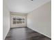 Bedroom with wood-look flooring and large window at 8437 Thunder Ridge Way # 202, Highlands Ranch, CO 80126