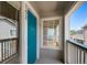 A charming front porch entryway features a vibrant blue door and sunny window at 8437 Thunder Ridge Way # 202, Highlands Ranch, CO 80126