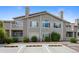 Exterior view of a two-story condo featuring balconies and a well-maintained landscape at 8437 Thunder Ridge Way # 202, Highlands Ranch, CO 80126