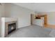 View of living room with fireplace that opens to kitchen with hard wood floors at 8437 Thunder Ridge Way # 202, Highlands Ranch, CO 80126
