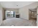 Spacious living room features a fireplace, carpet floors, and access to an outdoor patio at 8437 Thunder Ridge Way # 202, Highlands Ranch, CO 80126