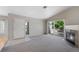 Bright living room with fireplace, carpet floors and sliding glass doors to the balcony at 8437 Thunder Ridge Way # 202, Highlands Ranch, CO 80126