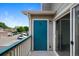Outdoor patio area with a teal accent door, accessible by a sliding glass door at 8437 Thunder Ridge Way # 202, Highlands Ranch, CO 80126