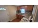 Cozy kitchen featuring wooden cabinets, granite countertops, tiled backsplash, and a gas range stove at 2880 W 91St Pl, Denver, CO 80260